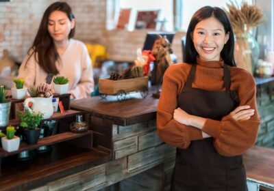 beautiful-attractive-asian-cafe-shop-owner-smile-with-happiness-joyful-with-coffee-cup-apron-cafe-background-1536×1025-1